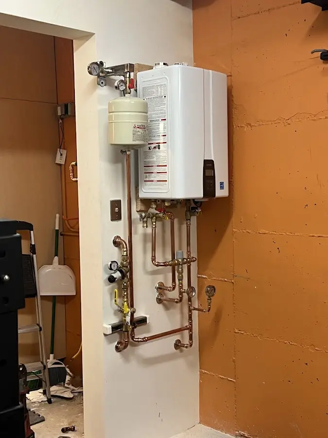 Plumbing technician inspecting water heater connections in Seal Beach